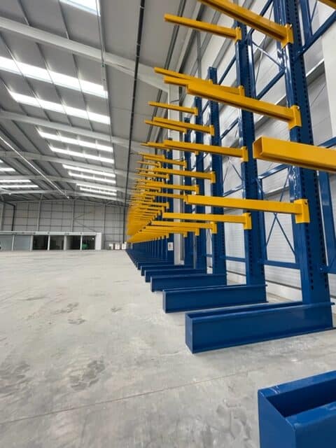 S.E.M.CO Single Sided Cantilever Racking being installed in a customer's warehouse space.